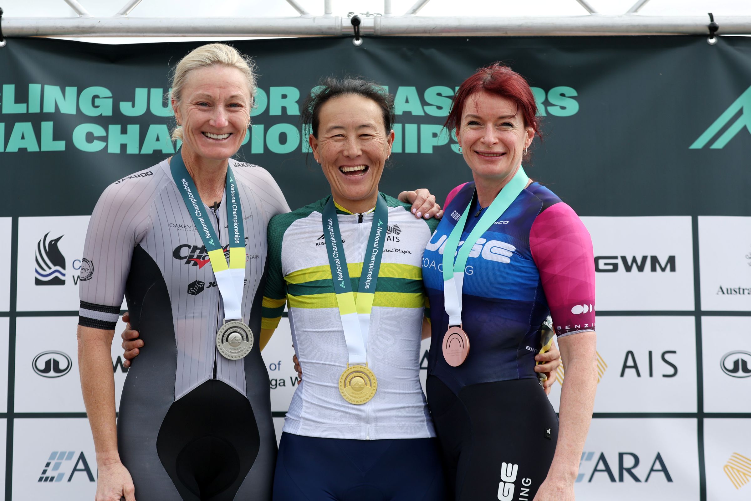 Three women smiling on the podium of an AusCycling Masters Road National Championship race